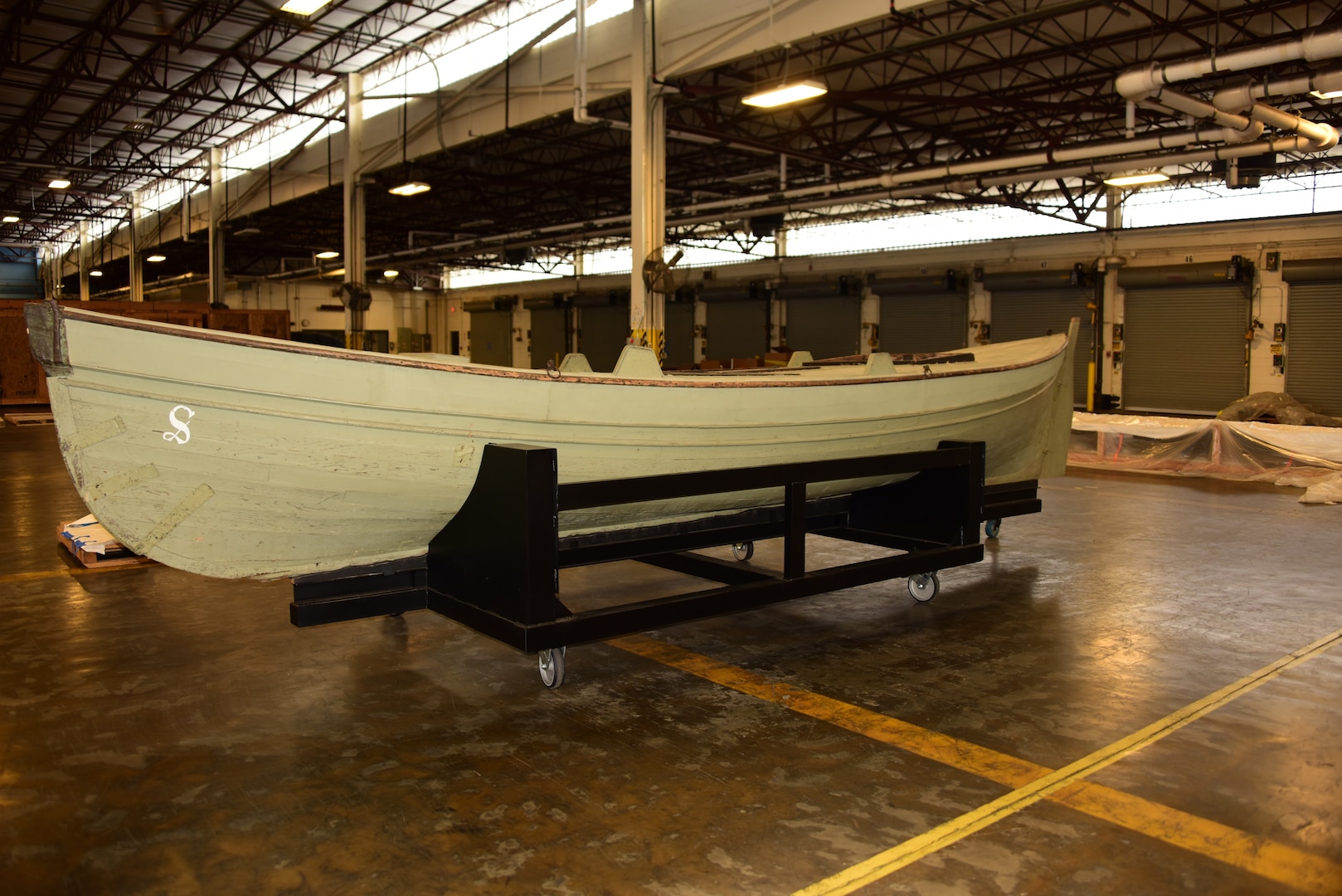 USS Saginaw’s gig rests on a steel mount at the Naval History and Heritage Command’s collection management facility.