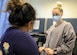 Image of an Airman talking to a patient