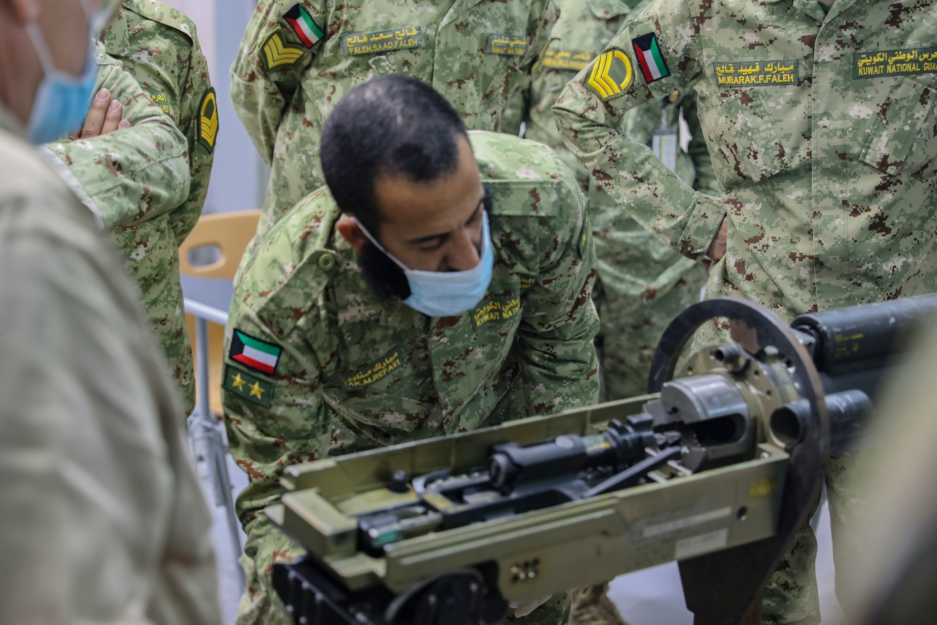 Staff Sgt. Christopher Doyle, 2nd Armored Brigade Combat Team, 1st Armored Division, brigade master gunner instructs Soldiers from the Kuwait National Guard on the M242 Bushmaster near Kuwait City, Kuwait, November 29, 2020. 2ABCT is deployed to southwest Asia in support of Operation Spartan Shield to support regional partners and sustain stability in the region. (U.S. Army Photo by: Staff Sgt. Michael West)