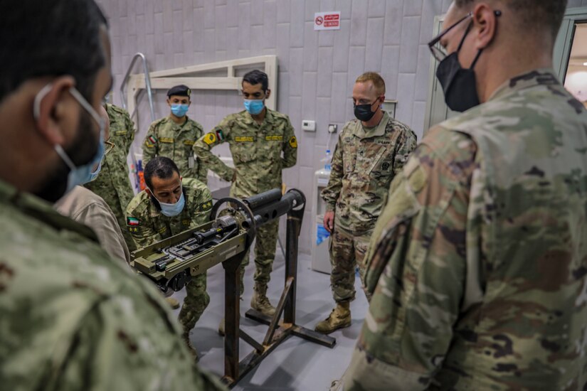 Staff Sgt. Christopher Doyle, 2nd Armored Brigade Combat Team, 1st Armored Division, brigade master gunner instructs Soldiers from the Kuwait National Guard on the M242 Bushmaster near Kuwait City, Kuwait, November 29, 2020. 2ABCT is deployed to southwest Asia in support of Operation Spartan Shield to support regional partners and sustain stability in the region. (U.S. Army Photo by: Staff Sgt. Michael West)