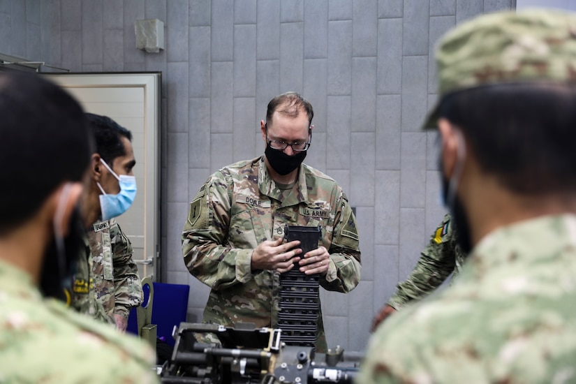 Staff Sgt. Christopher Doyle, 2nd Armored Brigade Combat Team, 1st Armored Division, brigade master gunner instructs Soldiers from the Kuwait National Guard on the M242 Bushmaster near Kuwait City, Kuwait, November 29, 2020. 2ABCT is deployed to southwest Asia in support of Operation Spartan Shield to support regional partners and sustain stability in the region. (U.S. Army Photo by: Staff Sgt. Michael West)