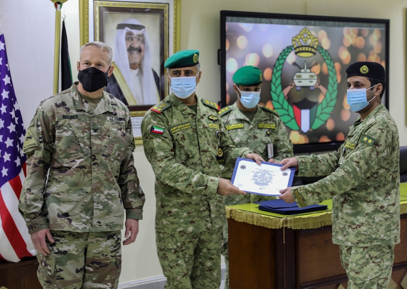 In a socially distanced ceremony full of senior military leaders from the Kuwait National Guard and 2nd Armored Brigade Combat Team, 1st Armored Division, Soldiers of the KNG were awarded course completion certificates near Kuwait City, Kuwait on December 7, 2020. 2ABCT is deployed to Southwest Asia in support of Operation Spartan Shield to support regional partners and sustain stability in the region. (U.S. Army Photo by: Staff Sgt. Michael West)