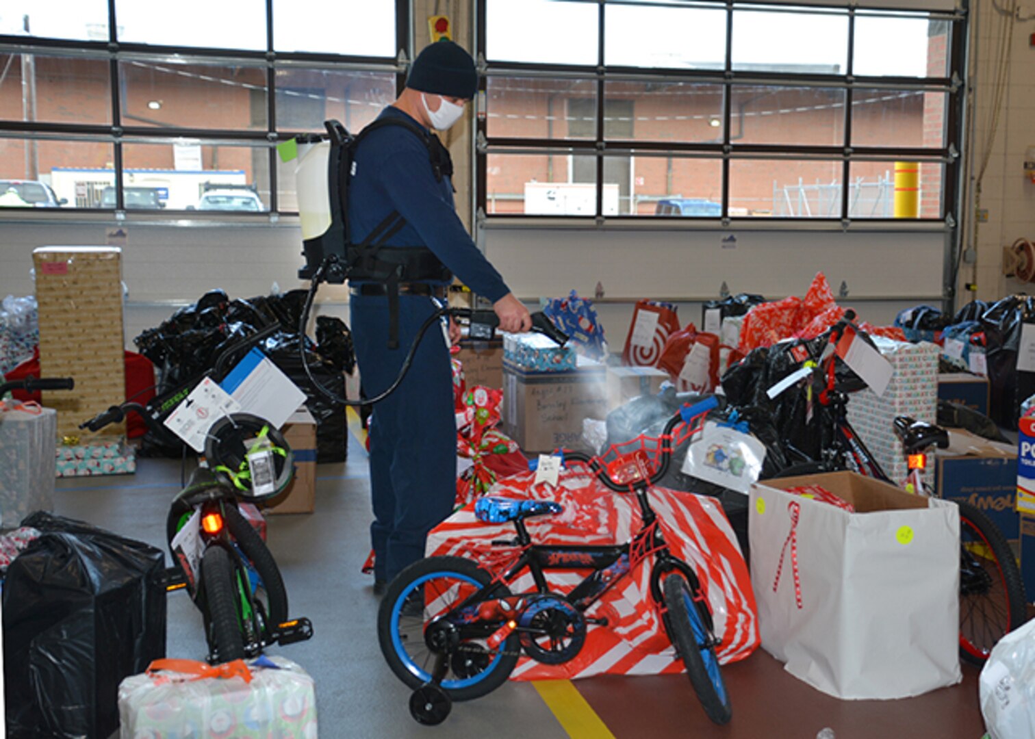 Firefighter Stephen Williamson disinfect Angel Tree gifts