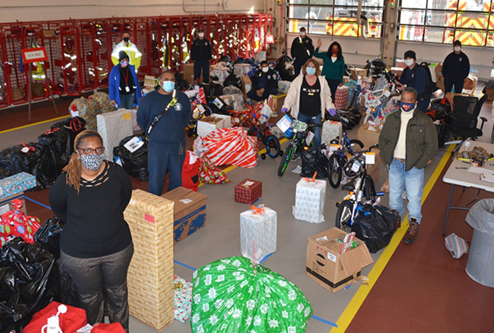 Team members stand with Angel Tree gifts