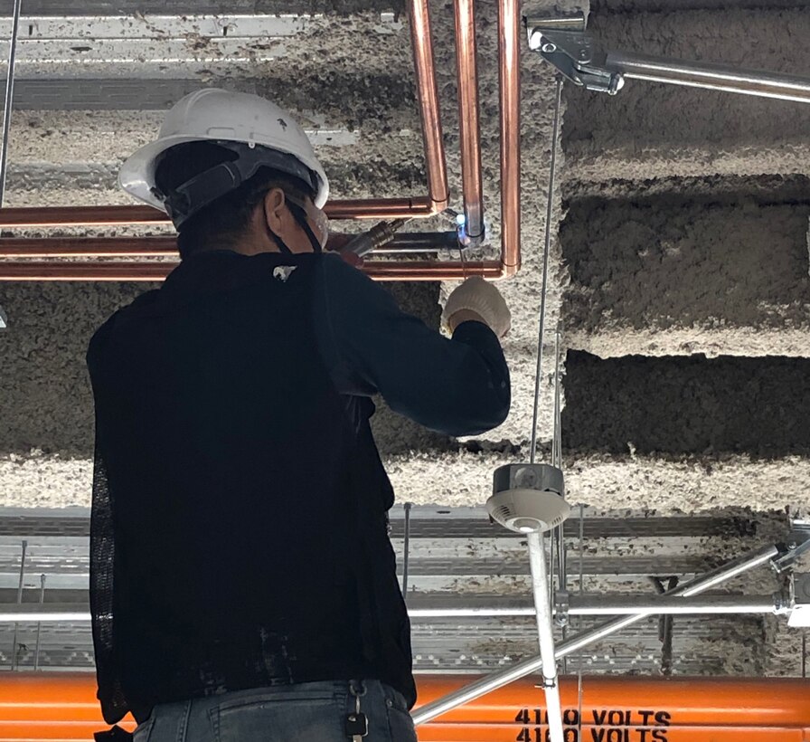 A worker installs piping to one of the three new ethylene oxide sterilizer systems at the Veterans Administrations New York Harbor Healthcare System Manhattan Campus. Huntsville Center’s Medical Outfitting and Transition program awarded its first IO&T project for the Department of Veterans Affairs in September.