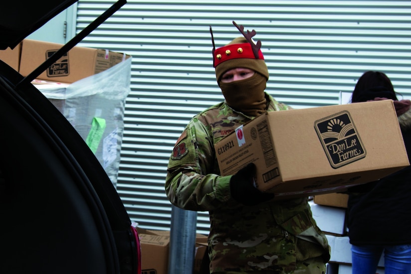 An airman loads a box.