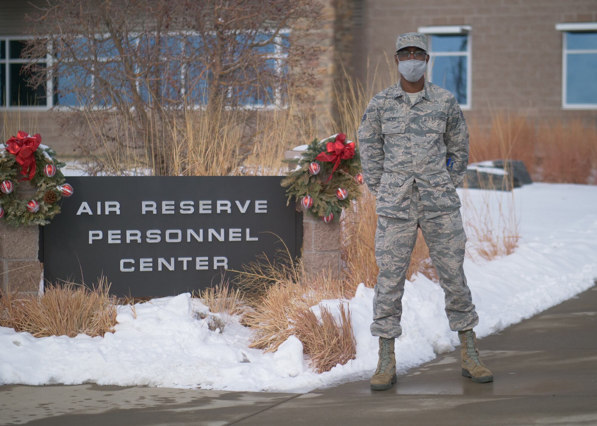 Senior Airman Lamont Hicks, a personnel specialist assigned o Headquarters Air Reserve Personnel Center, poses for a photo outside of the headquarters building Dec. 15, 2020, on Buckley Air Force Base, Colorado.