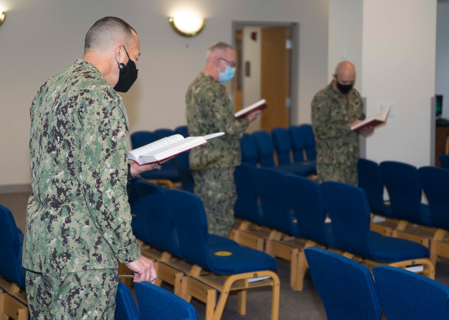 Naval Medical Center Portsmouth (NMCP) chaplains sing hymns during Lessons and Carols in NMCP’s Chapel on Dec. 11.