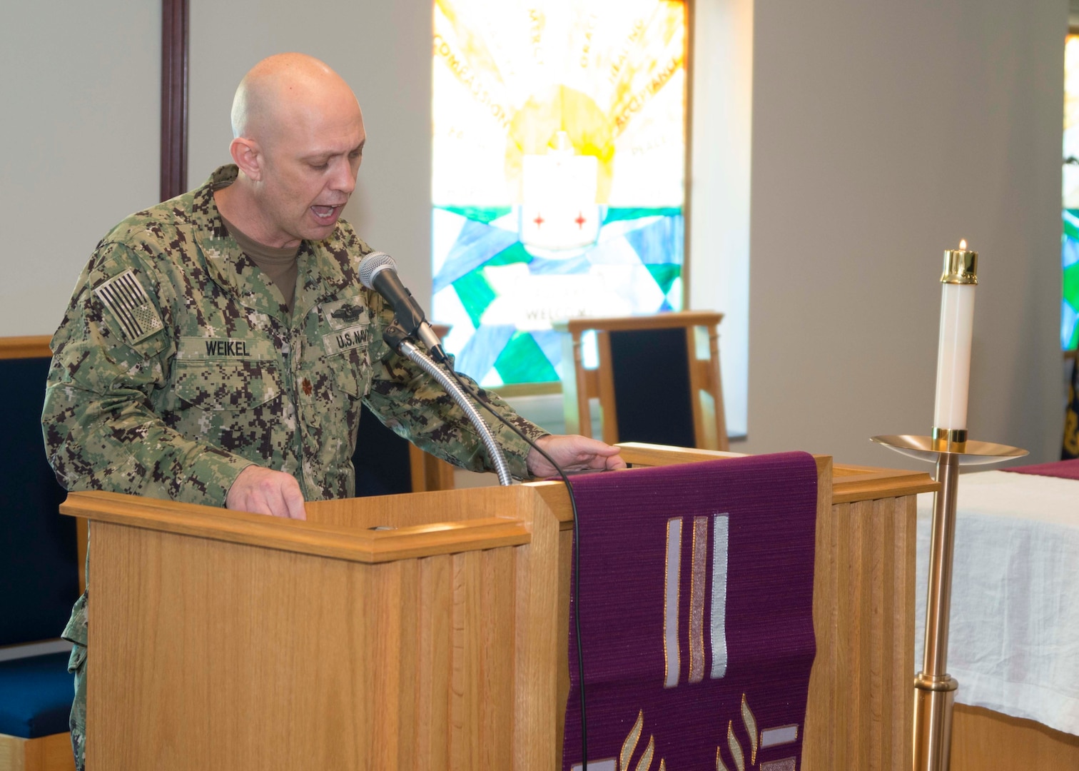 Lt. Cmdr. Ralph Weikel, a staff chaplain at Naval Medical Center Portsmouth (NMCP), speaks during Lessons and Carols in Naval Medical Center Portsmouth’s (NMCP) Chapel on Dec. 11.