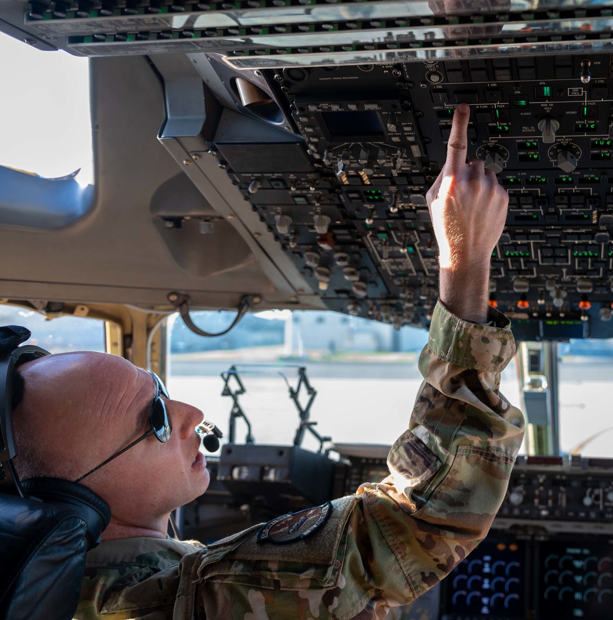 Maj. James Kovarovic, 3rd Airlift Squadron instructor pilot, conducts pre-flight checks aboard a C-17 Globemaster III prior to a training mission at Dover Air Force Base, Delaware, Dec. 10, 2020.  The 436th Airlift Wing routinely conducts training missions in support of rapid, global mobility and readiness. (U.S. Air Force photo by Airman 1st Class Faith Schaefer)