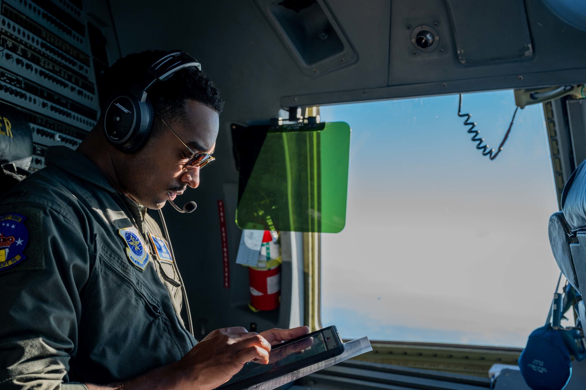 1st Lt. Robert Farley, 3rd Airlift Squadron pilot, checks the weather aboard a C-17 Globemaster III prior to low-level training over eastern Tennessee, Dec. 10, 2020. The 436th Airlift Wing routinely flies training missions to maintain mission readiness.  (U.S. Air Force photo by Airman 1st Class Faith Schaefer)
