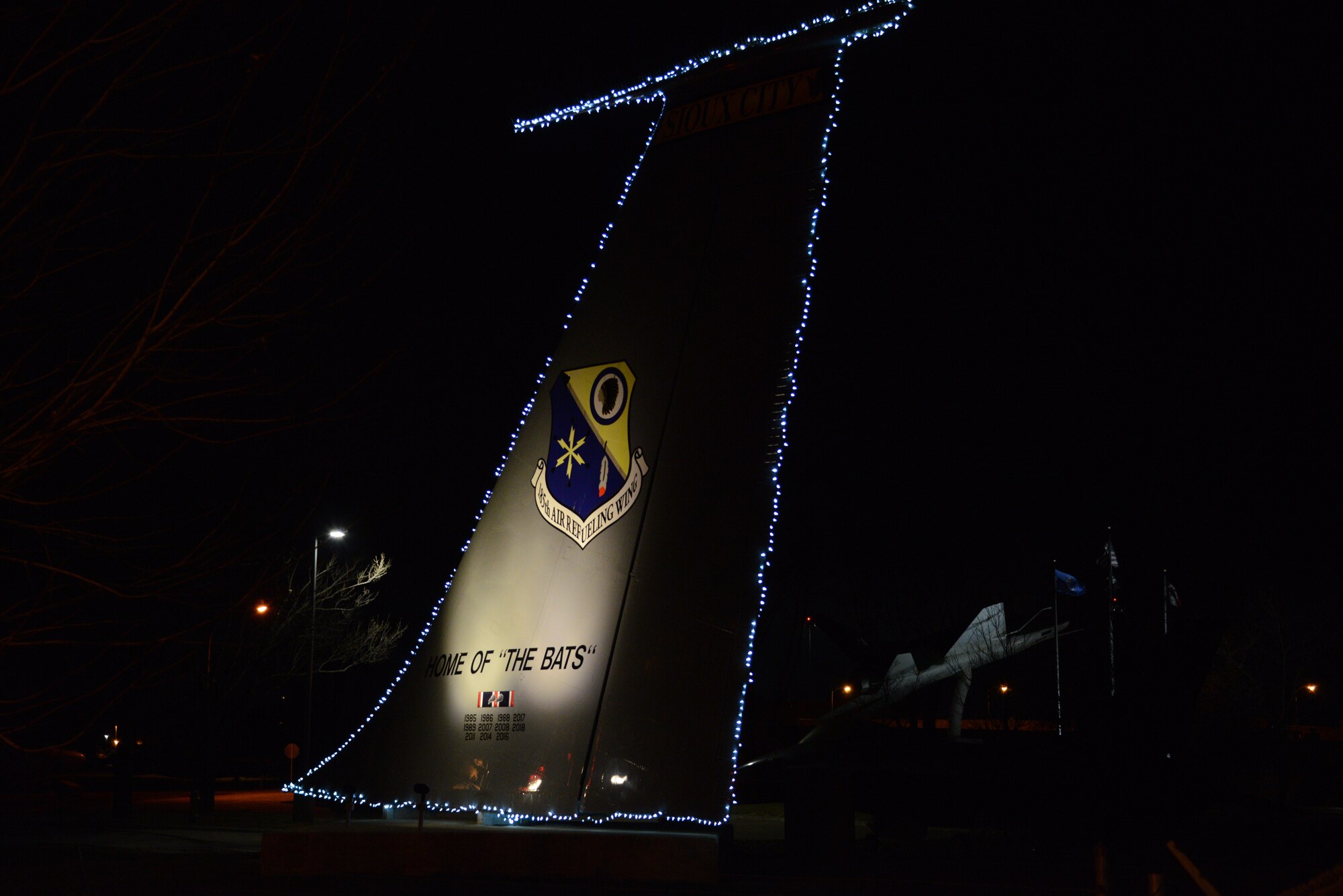 The tail of a KC-135 static display is decorated with Christmas lights near the main entrance of the 185th Air Refueling Wing