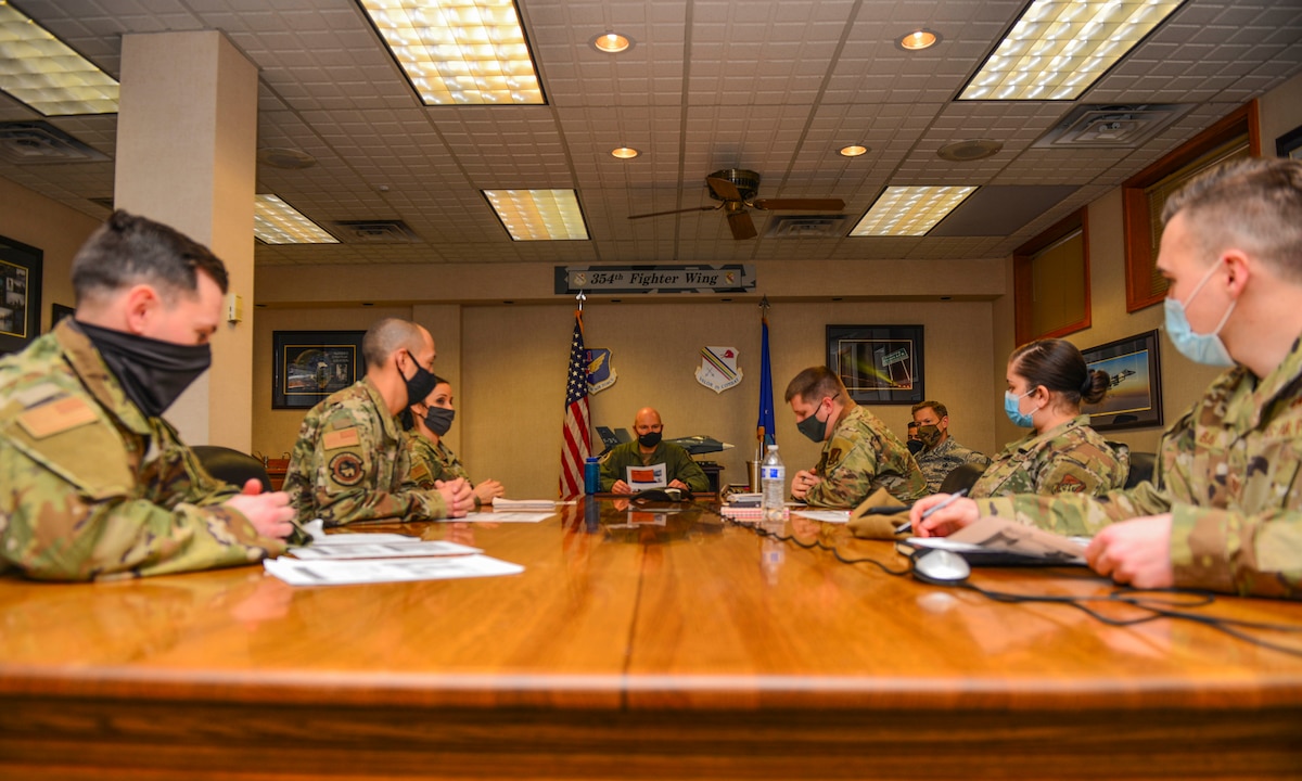 U.S. Air Force Col. David Berkland, the 354th Fighter Wing (FW) commander, and Chief Master Sgt. John Lokken, the 354th FW command chief, meets with the innovation team during a wing leadership immersion on Eielson Air Force Base, Alaska, Dec. 11, 2020.