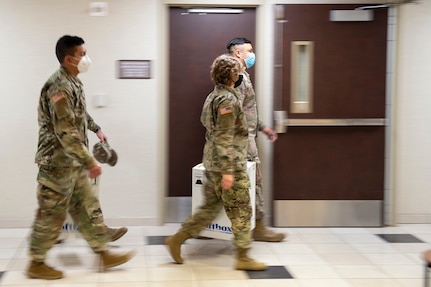 Oklahoma National Guardsmen quickly move boxes containing COVID-19 vaccinations to vehicles the Guard members will use to transport the vaccines to sites across the state, Dec. 15, 2020.

These are the first two boxes of vaccines to be distributed from one of five centralized hubs supporting 11 satellite locations across Oklahoma. The Guardsmen will be using Oklahoma State Department of Health vehicles to transport the vaccines to the satellite locations with an escort from the Oklahoma Highway Patrol. (Oklahoma National Guard photo by Anthony Jones)