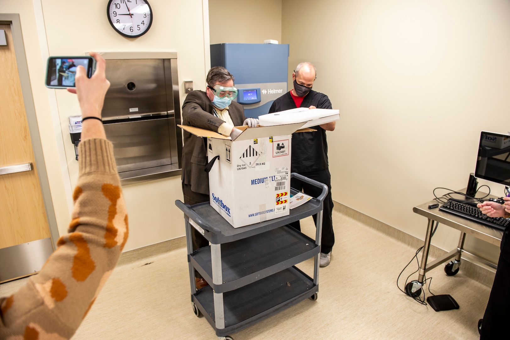 Shane Edmonson, executive director of pharmacy services, unseals the first shipment of COVID-19 vaccines delivered by Oklahoma National Guardsmen at the Mercy Hospital in Northwest Oklahoma City, Dec. 15, 2020.

The vaccines were delivered by Spc. Martin Gamarra and Airman 1st Class Andreas Owens. Gamarra and Owen are part of a larger team of Guardsmen who are delivering vaccines from from one of five centralized hubs supporting 11 satellite locations across Oklahoma. The Guardsmen will be using Oklahoma State Department of Health vehicles to transport the vaccines to the satellite locations with an escort from the Oklahoma Highway Patrol. (Oklahoma National Guard photo by Anthony Jones)