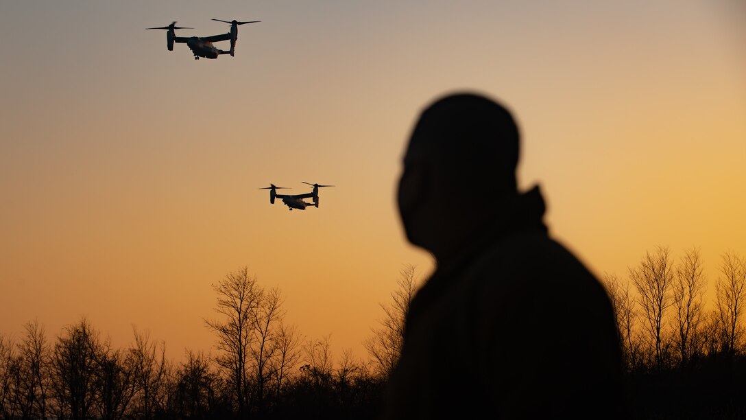 A U.S. Marine with Marine Medium Tiltrotor Squadron (VMM) 265, 1st Marine Aircraft Wing observes a MV-22B Osprey come in for landing at the flight line during exercise Forest Light Western Army at Camp Soumagahara, Gunma Prefecture, Japan, Dec. 03, 2020. Forest Light is an annual bilateral training exercise that strengthens the interoperability and readiness of the U.S. Marine Corps and Japan Ground Self-Defense Force to deter aggression and defeat any threat. This iteration is focused on seizing and defending key maritime terrain as an integrated force in support of naval operations in the defense of Japan. (Marine Corps photo by Sgt. Branden J. Bourque)