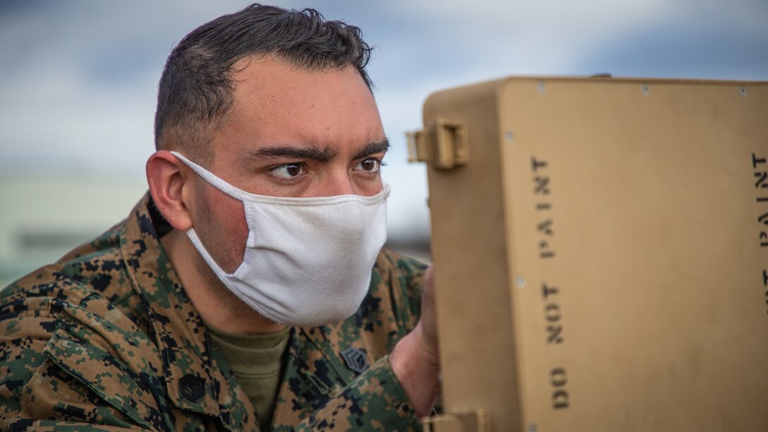 U.S. Marine Corps Staff Sgt. David Cardonasoto, a navigational aids technician chief, with Marine Air Control Squadron (MACS) 4, 1st Marine Aircraft Wing sets up an airfield mobile tactical air navigation system at the flight line during exercise Forest Light Western Army at Camp Soumagahara, Gunma Prefecture, Japan, Dec. 5, 2020. Forest Light is an annual bilateral training exercise that strengthens the interoperability and readiness of the U.S. Marine Corps and Japan Ground Self-Defense Force to deter aggression and defeat any threat. This iteration is focused on seizing and defending key maritime terrain as an integrated force in support of naval operations in the defense of Japan. (U.S. Marine Corps photo by Sgt. Branden J. Bourque)
