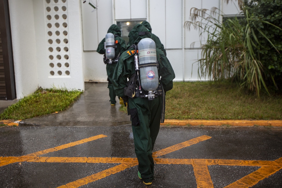U.S. Marines with Chemical; Biological; Radiological; and Nuclear defense; 1st Marine Aircraft Wing; approach a building during hazardous environment training at Camp Lester; Okinawa; Japan; Dec. 9; 2020. This training event was conducted to strengthen the unit’s proficiency and readiness when operating in hazardous environments. (U.S. Marine Corps photo by Cpl. Ethan M. LeBlanc)