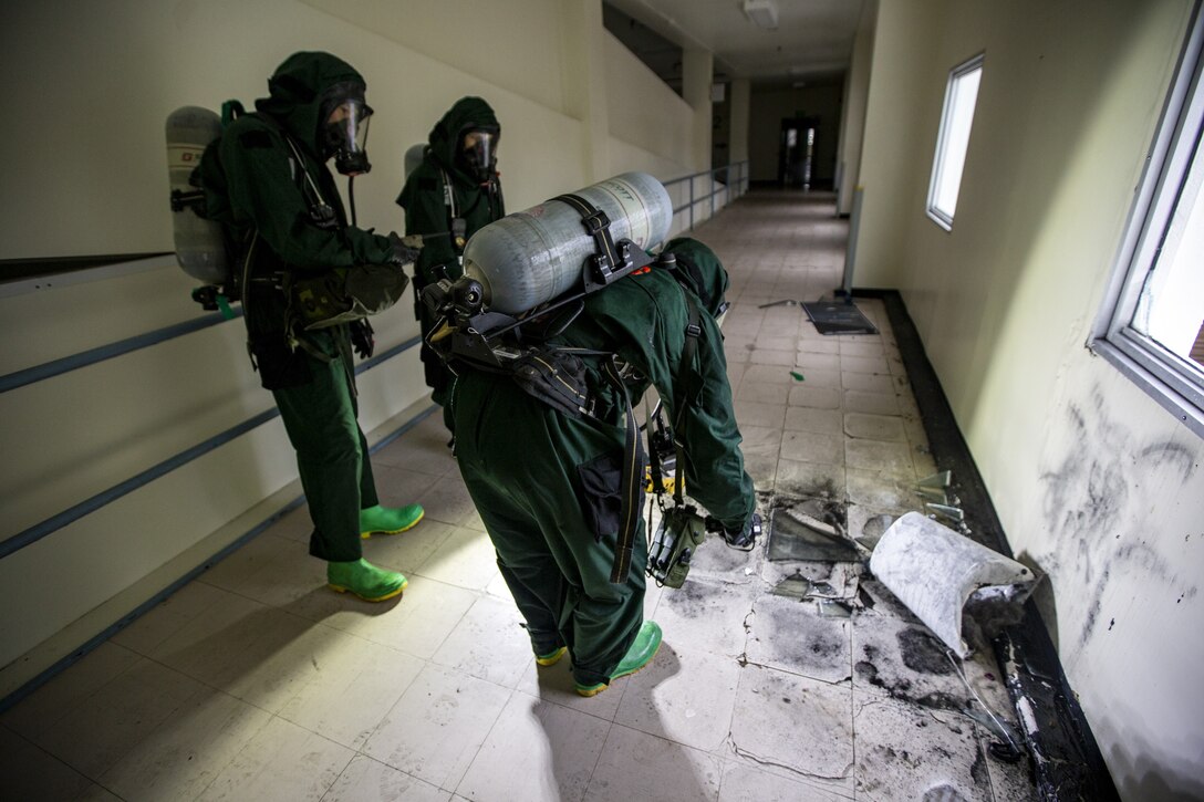 U.S. Marines with Chemical, Biological, Radiological, and Nuclear defense, 1st Marine Aircraft Wing, gather information during hazardous environment training at Camp Lester, Okinawa, Japan, Dec. 9, 2020. This training event was conducted to strengthen the unit’s proficiency and readiness when operating in hazardous environments. (U.S. Marine Corps photo by Cpl. Ethan M. LeBlanc)