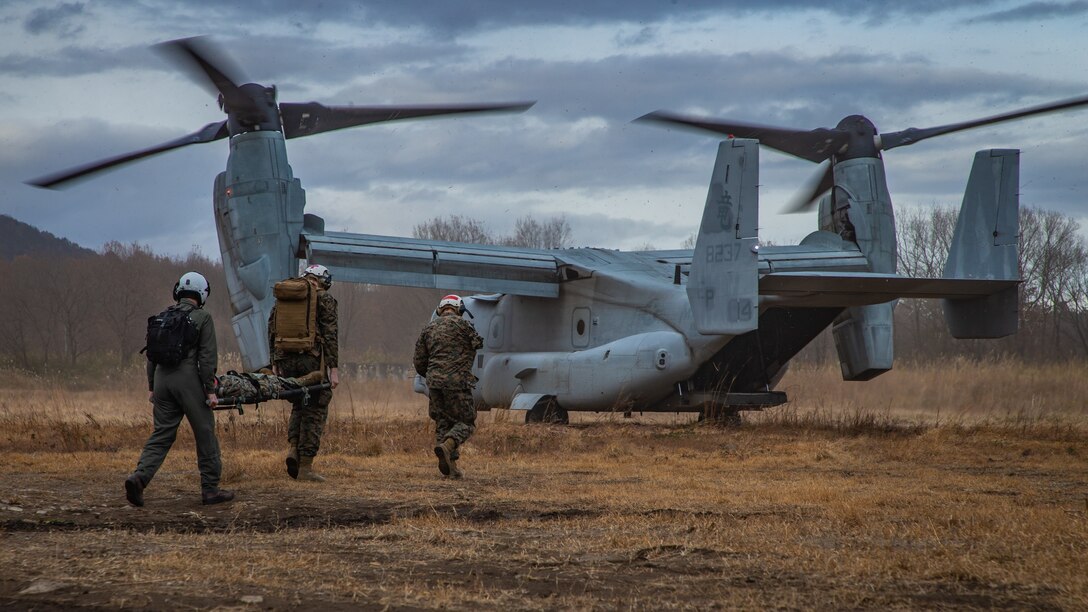 U.S. Marines with Marine Medium Tiltrotor Squadron (VMM) 265, 1st Marine Aircraft Wing carry a casualty to an MV-22B Osprey during exercise Forest Light Western Army at Camp Soumagahara, Gunma Prefecture, Japan, Dec. 12, 2020. Forest Light is an annual bilateral training exercise that strengthens the interoperability and readiness of the U.S. Marine Corps and Japan Ground Self-Defense Force to deter aggression and defeat any threat. This iteration is focused on seizing and defending key maritime terrain as an integrated force in support of naval operations in the defense of Japan. (U.S. Marine Corps photo by Sgt. Branden J. Bourque)