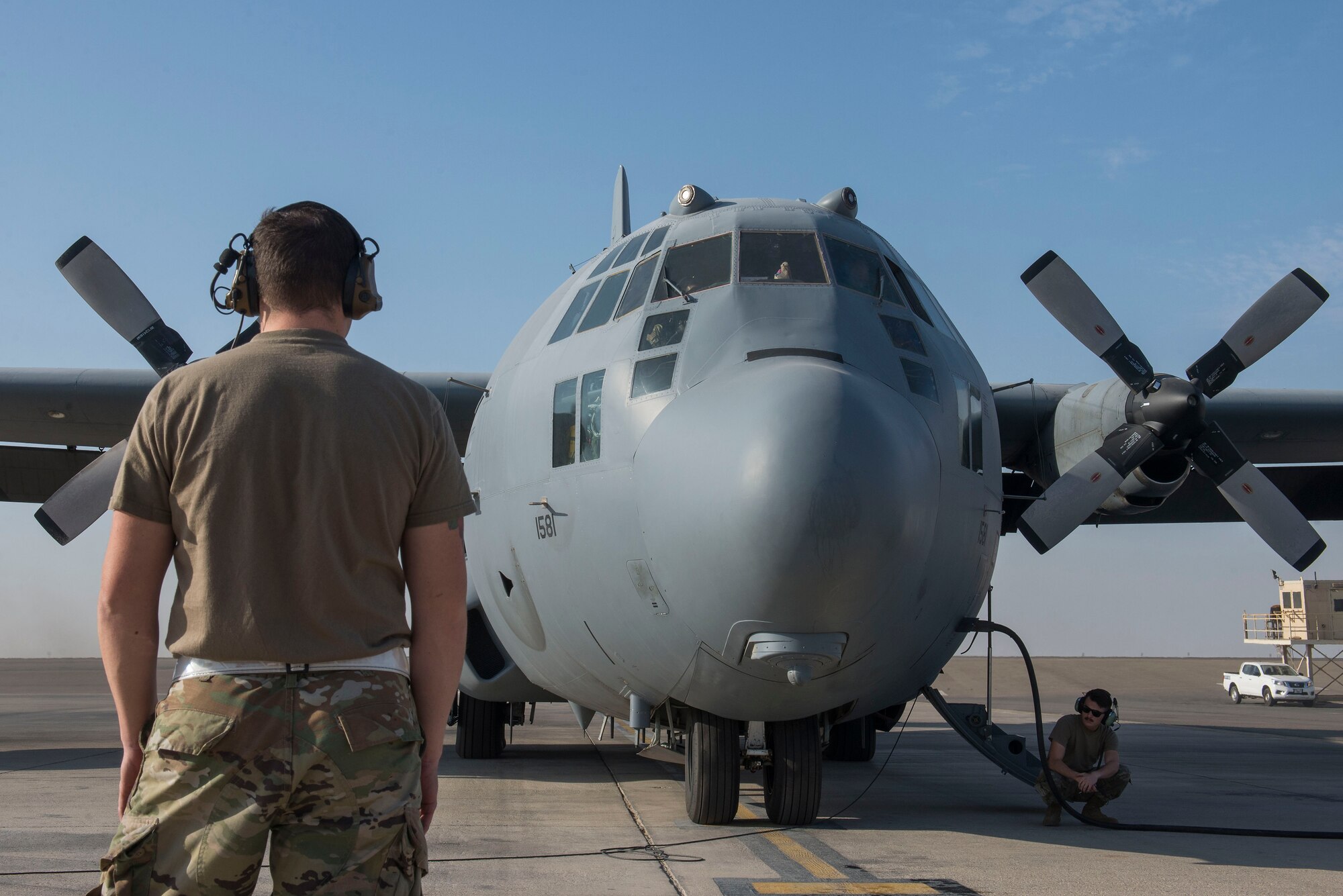A U.S. Airman assigned to the 380th Expeditionary Maintenance Group performs pre-flight operations on an EC-130H Compass Call assigned to the 41st Expeditionary Electronic Combat Squadron during a rapid employment, defense, and survivability exercise at Al Dhafra Air Base, United Arab Emirates, Nov. 28, 2020.