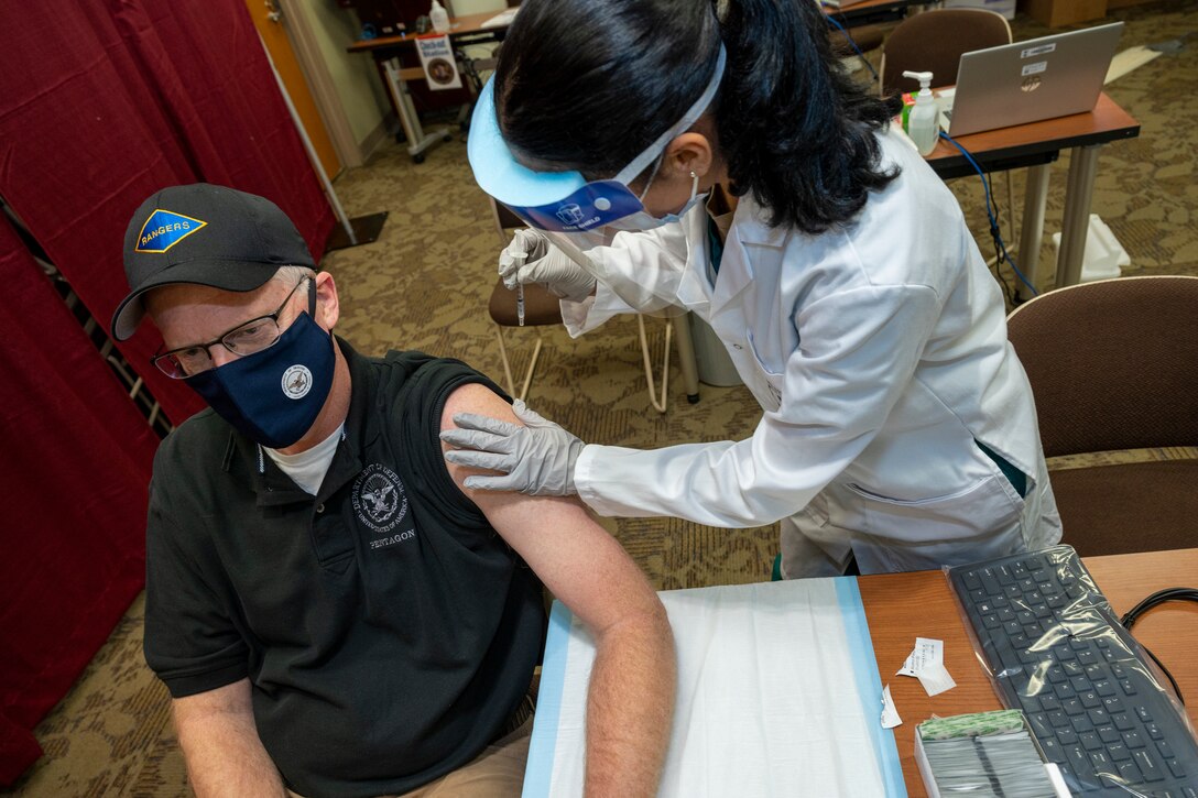 Acting Defense Secretary Chris Miller receives the COVID-19 vaccine.