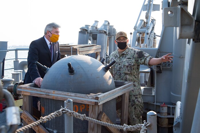 201215-N-IO414-1059 NAVAL SUPPORT ACTIVITY BAHRAIN (Dec. 15, 2020) Mineman 2nd Class Juan Cruz speaks with Secretary of the Navy Kenneth J. Braithwaite about the capabilities of the mine countermeasure ship USS Devastator (MCM 6) during his visit with personnel on board U.S. Naval Support Activity Bahrain, Dec. 15. Devastator is deployed to the U.S. 5th Fleet area of operations in support of naval operations to ensure maritime stability in the Central Region, connecting the Mediterranean and Pacific through the Western Indian Ocean and three critical chokepoints to the free flow of global commerce.