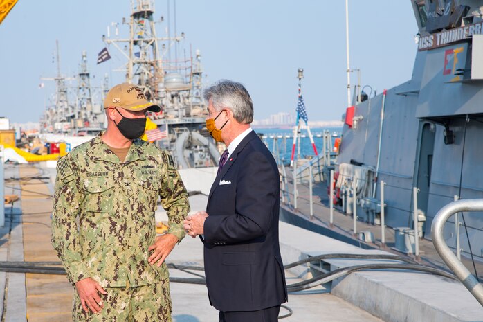 201215-N-IO414-1102 NAVAL SUPPORT ACTIVITY BAHRAIN (Dec. 15, 2020) Capt. Michael Brasseur, deputy commander of Commander, Task force (CTF) 55, speaks with Secretary of the Navy Kenneth J. Braithwaite during his visit with personnel on board U.S. Naval Support Activity Bahrain, Dec. 15. CTF 55 commands surface forces such as U.S. Navy patrol craft, U.S. Coast Guard patrol boats and independently deployed ships in U.S. 5th Fleet area of operations in support of naval operations to ensure maritime stability in the Central Region.