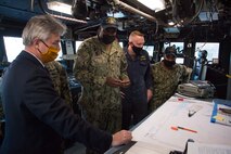 201215-N-IO414-1119 NAVAL SUPPORT ACTIVITY BAHRAIN (Dec. 15, 2020) Quartermaster 2nd Class Unique Thomas speaks with Secretary of the Navy Kenneth J. Braithwaite about navigational equipment aboard the patrol coastal ship USS Thunderbolt (PC 12) during his visit with personnel on board U.S. Naval Support Activity Bahrain, Dec. 15. Thunderbolt is deployed to the U.S. 5th Fleet area of operations in support of naval operations to ensure maritime stability in the Central Region, connecting the Mediterranean and Pacific through the Western Indian Ocean and three critical chokepoints to the free flow of global commerce.