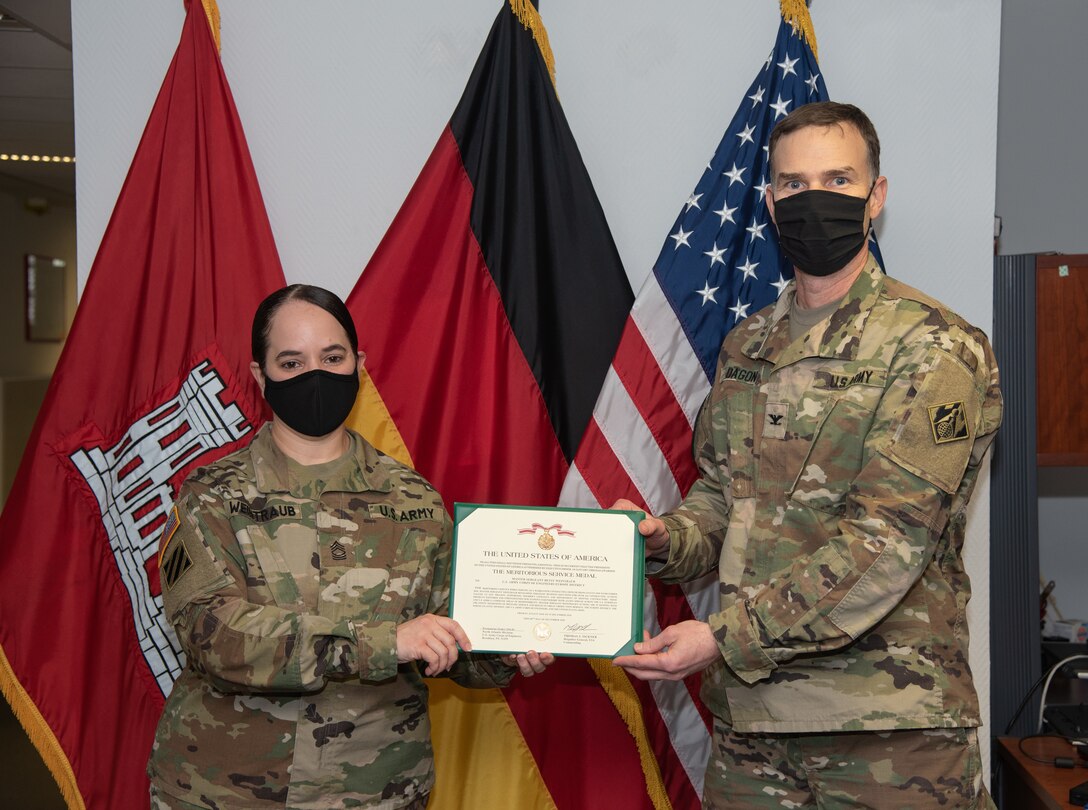 U.S. Army Master Sgt. Betsy Weintraub receives the Meritorious Service Medal from U.S. Army Corps of Engineers, Europe District commander.