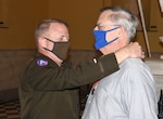 Maj. Gen. Timothy P. Williams, the Adjutant General of Virginia, presents the Ancient Order of St. Barbara to retired Col. Mike Coleman during a ceremony at the Capitol of Virginia Dec. 14, 2020, in Richmond, Virginia.