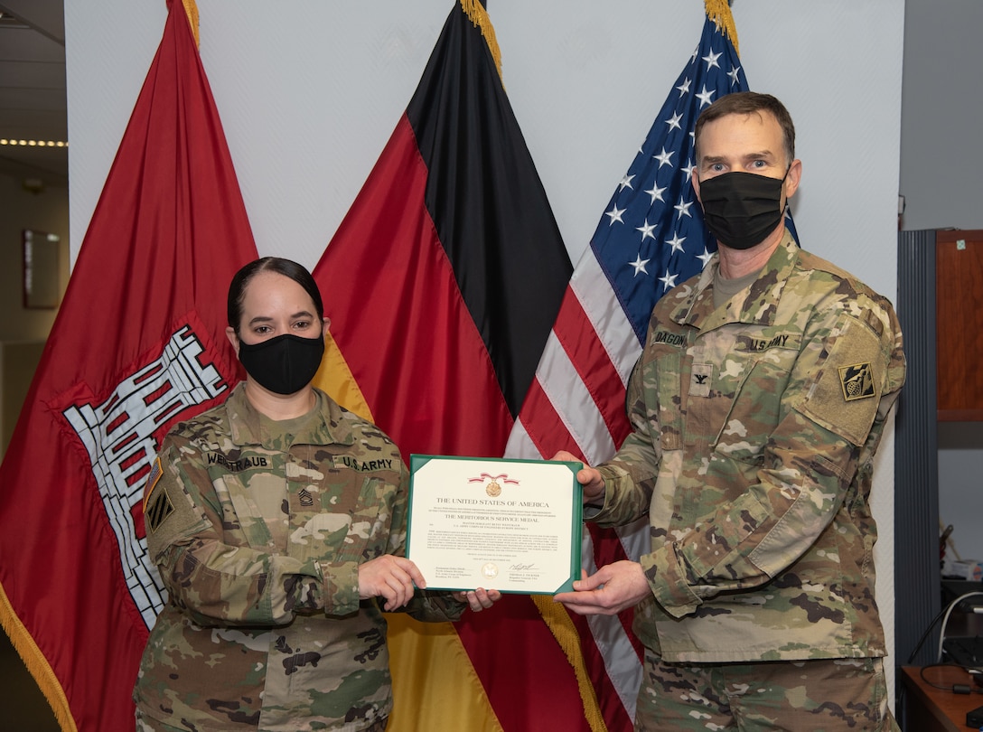 U.S. Army Master Sgt. Betsy Weintraub receives the Meritorious Service Medal from U.S. Army Corps of Engineers, Europe District commander.