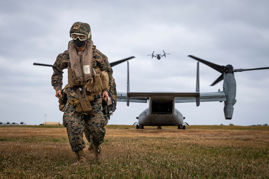 A U.S. Navy sailor carries a simulated casualty during En Route Care training as part of a MEU Exercise at Ie Shima Auxiliary Airfield, Japan, Dec. 8.