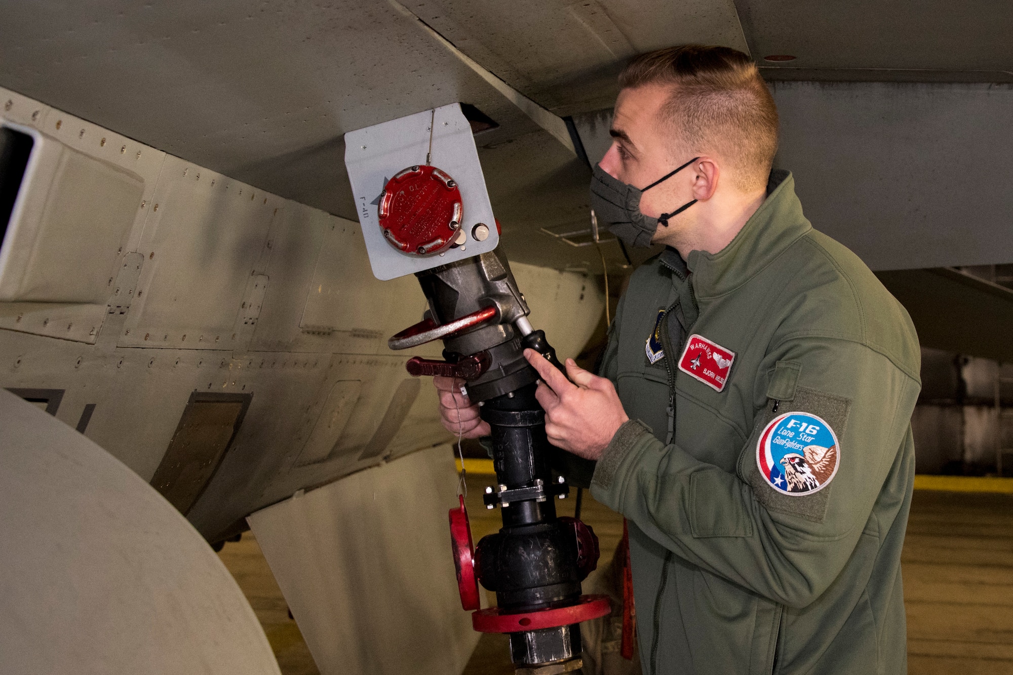 U.S. Air Force First Lt. Bjorn Nielsen, 480th Expeditionary Fighter Squadron pilot, inserts a fuel
pump into an F-16 Fighting Falcon during an Agile Combat Employment training at Spangdahlem Air Base, Germany, Dec. 11, 2020. This training allows for the pilots to
become more versatile, minimize aircraft downtime and increase mission effectiveness in a
deployed environment. (U.S. Air Force photo by Senior Airman Chance D. Nardone)