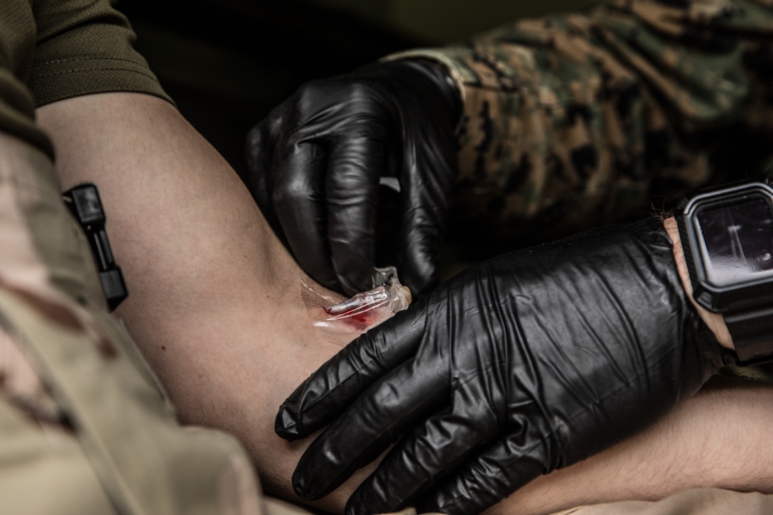 A U.S. Marine participates in a blood transfusion practical application during exercise Steel Knight at Marine Corps Base Camp Pendleton, Calif., Dec. 7.