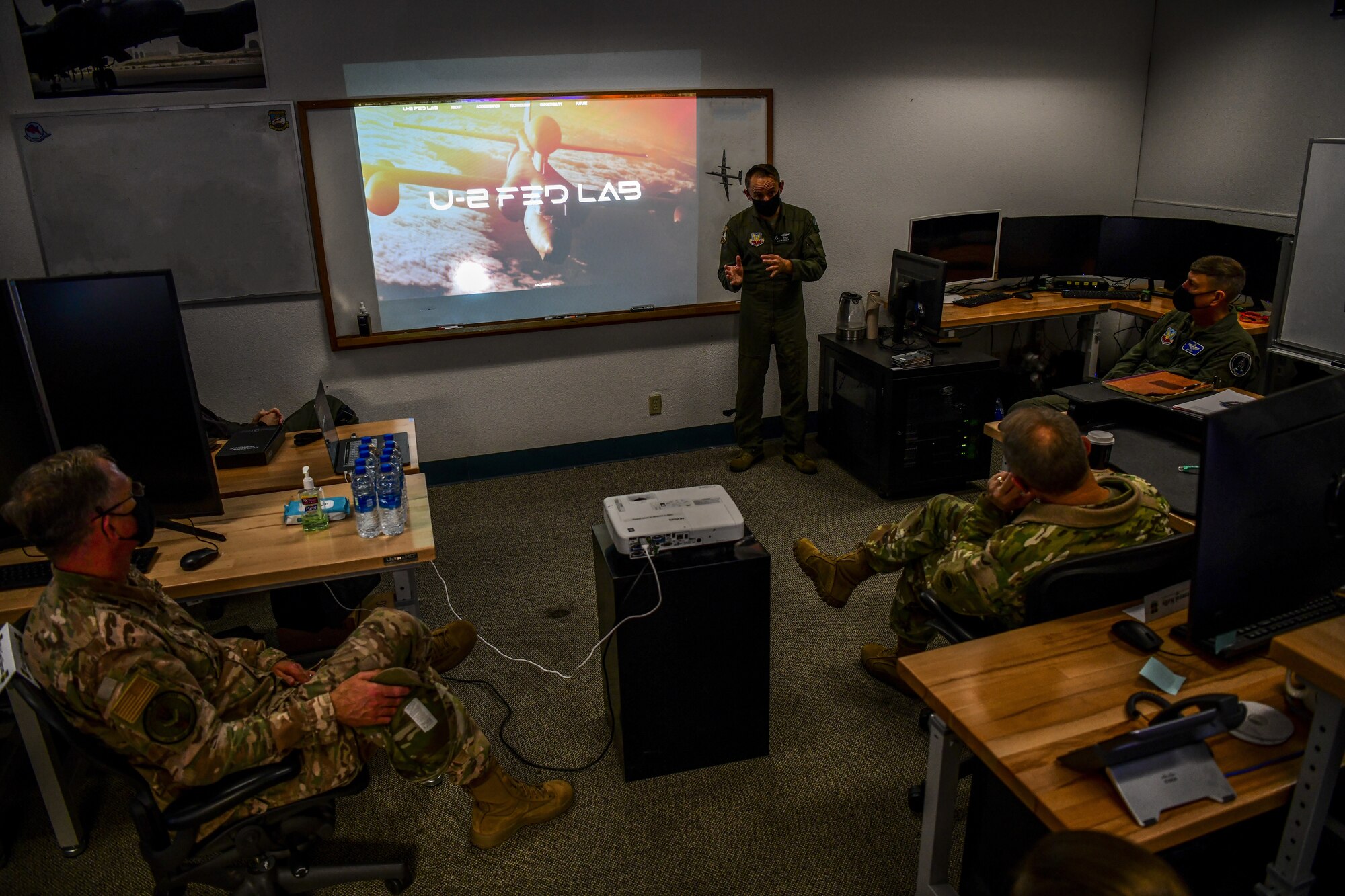 Gen. Mark Kelly, right, commander of Air Combat Command, and Command Chief Master Sgt. David Wade, ACC, receive a briefing from U-2 Federal Laboratory staff about the organization’s stand-up and recent projects, Dec. 4, 2020, at Beale Air Force Base, Calif. The U-2 Federal Laboratory is the first of its kind in the Department of Defense; offering a small team of experts tackling challenges through creation, development, acquisition, and testing of new technologies with the purpose of shaping how the service maintains an advantage over near-peer adversaries. (This photo has been edited due to operational security. (U.S. Air Force photo by Staff Sgt. Colville McFee)