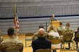 Lt. Col. Jeremy Stevenson stands behind podium and speaks to audience.