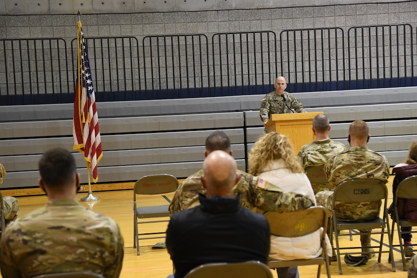 Lt. Col. Jeremy Stevenson stands behind podium and speaks to audience.