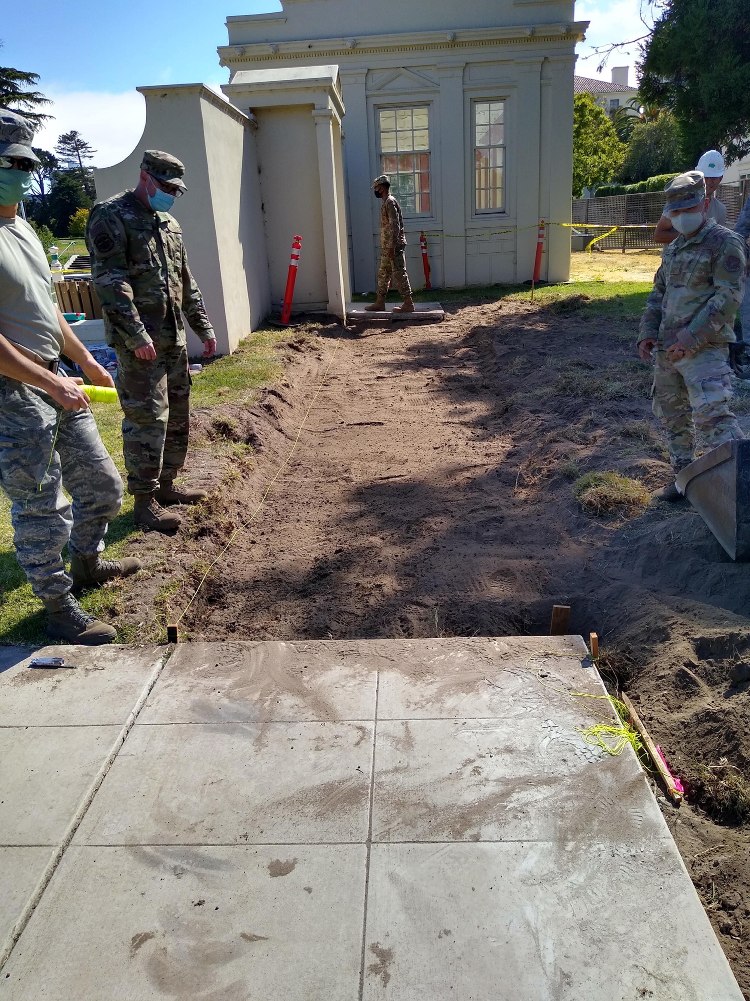 Members of the 349th Civil Engineer Squadron, Travis Air Force Base, California,  conducted an annual tour at the Naval Support Activity Monterey, a military university in Monterey, California, July 13-27, 2020. In this photo, Airmen Engineers improve access to the pump house by constructing a new 20’ by 70’ road and installing entry doors.