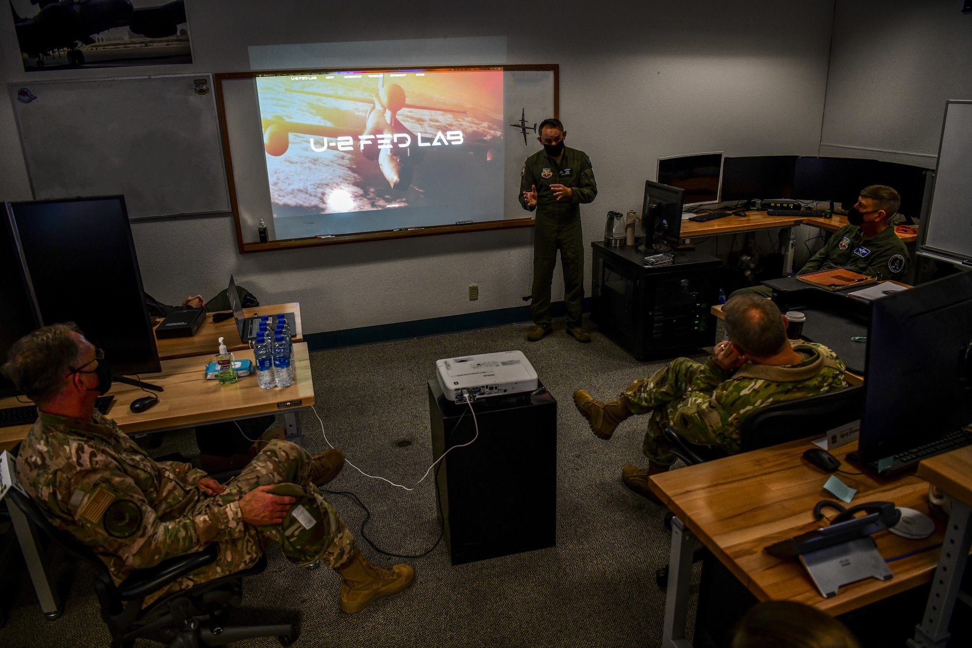 Gen. Mark Kelly, right, commander of Air Combat Command, and Command Chief Master Sgt. David Wade, ACC, receive a briefing from U-2 Federal Laboratory staff about the organization’s stand-up and recent projects, Dec. 4, 2020, at Beale Air Force Base, Calif. The U-2 Federal Laboratory is the first of its kind in the Department of Defense; offering a small team of experts tackling challenges through creation, development, acquisition, and testing of new technologies with the purpose of shaping how the service maintains an advantage over near-peer adversaries. (This photo has been edited due to operational security. (U.S. Air Force photo by Staff Sgt. Colville McFee)