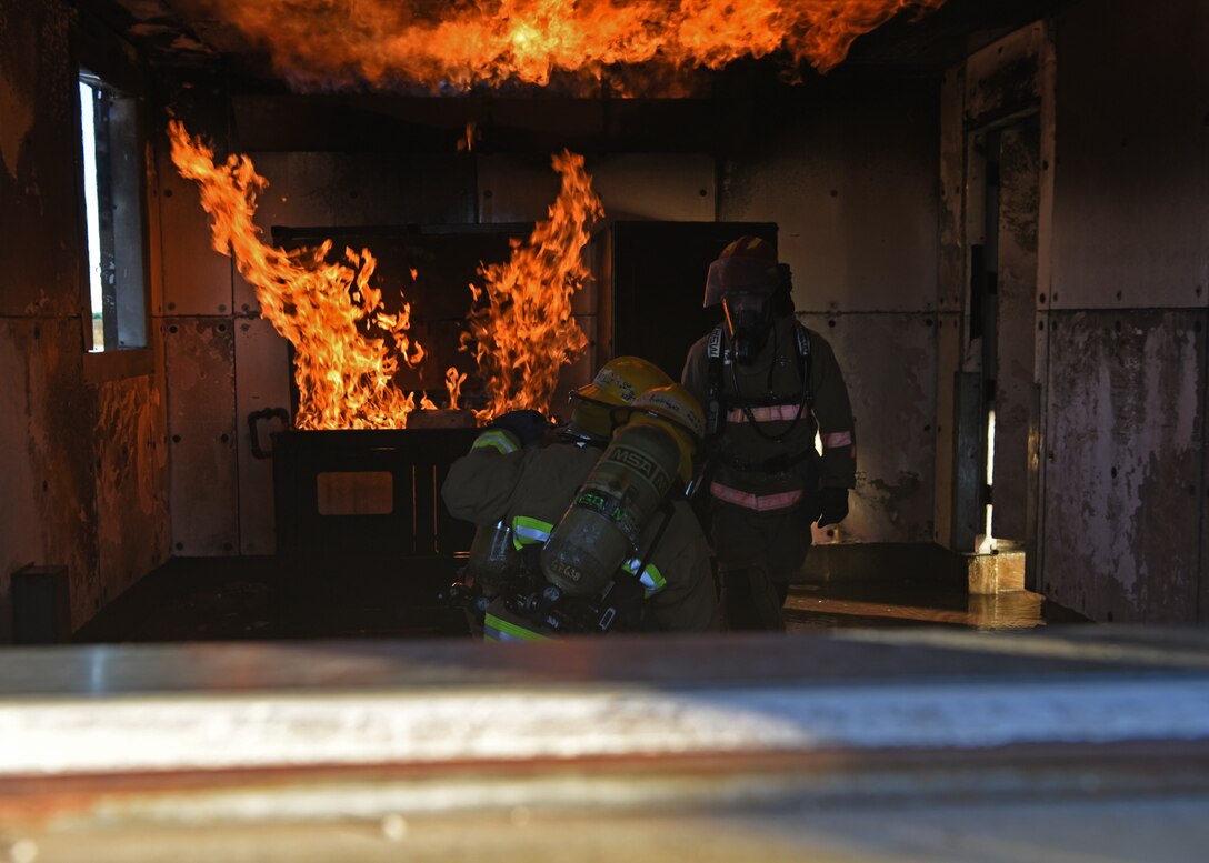oint service fire protection students from the 312th Training Squadron orient themselves to the burning environment while under the supervision of their instructor during the grade level interior fire training exercise at the Louis F. Garland Department of Defense Fire Academy on Goodfellow Air Force Base, Texas, Dec. 10, 2020. The students were tested in a safe, yet realistic joint learning environment on how to suppress kitchen fires and other customizable scenarios. (U.S. Air Force photo by Senior Airman Abbey Rieves)