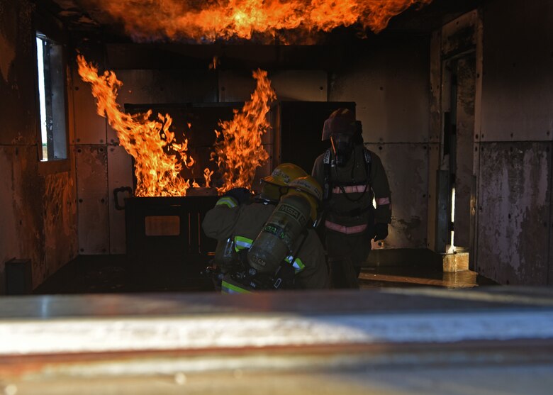 oint service fire protection students from the 312th Training Squadron orient themselves to the burning environment while under the supervision of their instructor during the grade level interior fire training exercise at the Louis F. Garland Department of Defense Fire Academy on Goodfellow Air Force Base, Texas, Dec. 10, 2020. The students were tested in a safe, yet realistic joint learning environment on how to suppress kitchen fires and other customizable scenarios. (U.S. Air Force photo by Senior Airman Abbey Rieves)