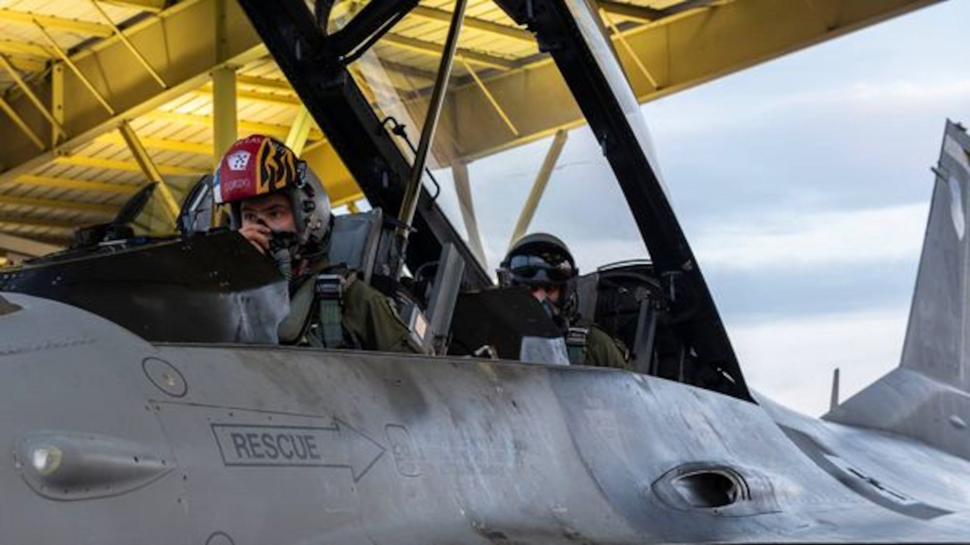 A photo of two people in the cockpit of an F-16 Fighting Falcon.