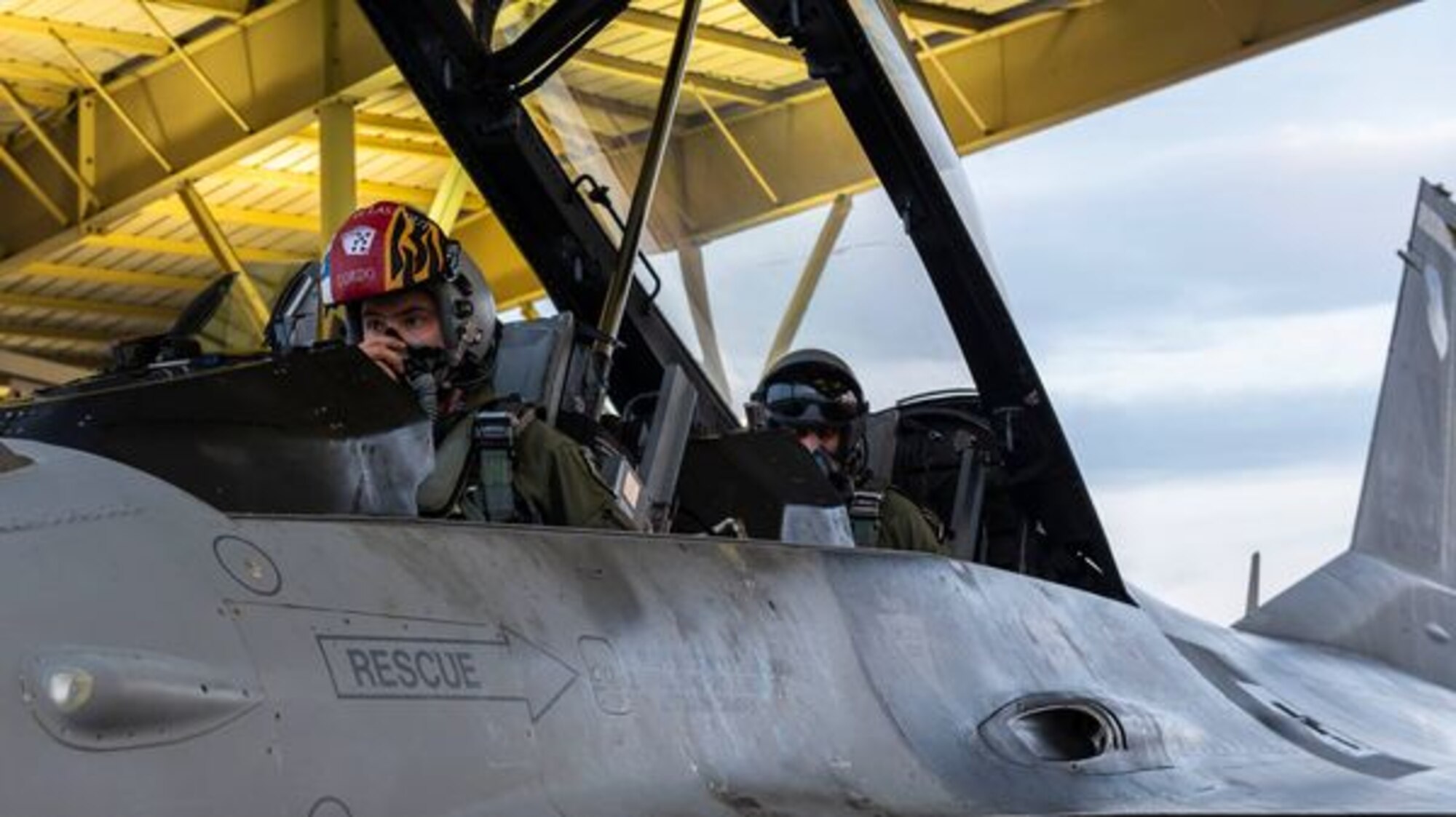 A photo of two people in the cockpit of an F-16 Fighting Falcon.