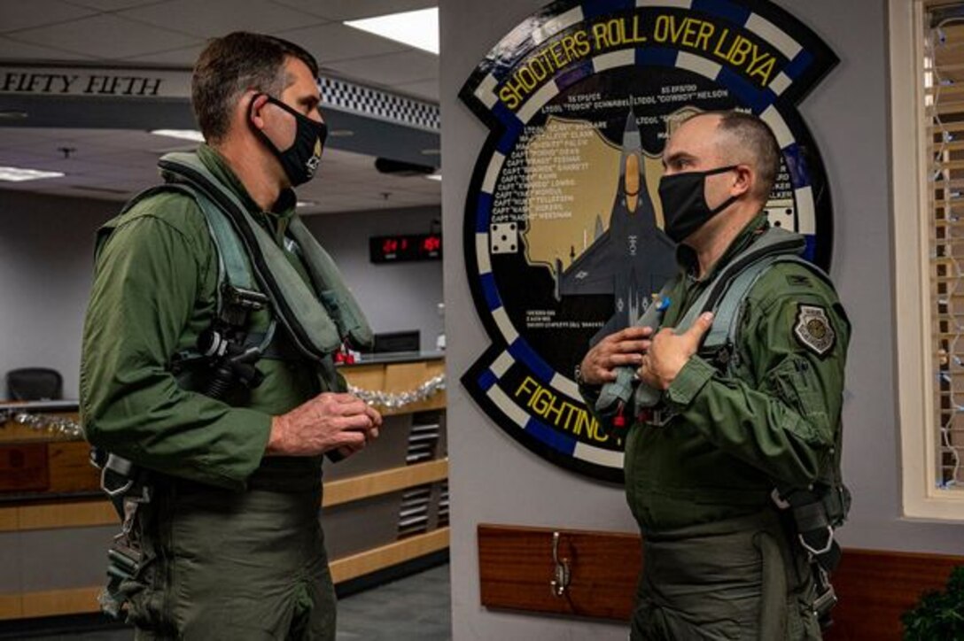 A photo of two people in flight suits.