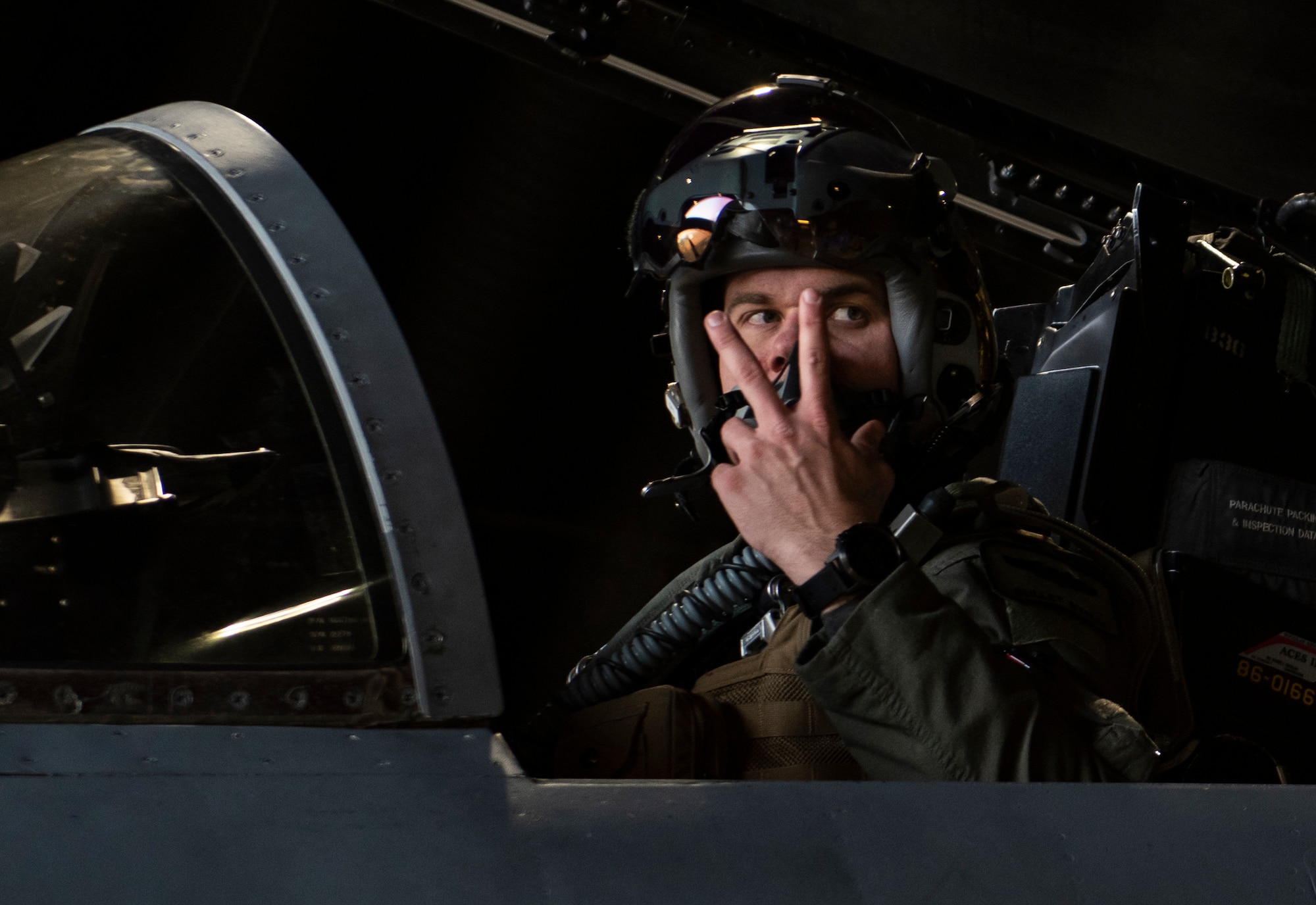 U.S. Air Force Capt. John Bynum, an electronic combat pilot assigned to the 493rd Fighter Squadron, gives the signal for engine start prior to take-off at Royal Air Force Lakenheath, England, Dec. 8, 2020. 48th Fighter Wing pilots participated in a live missile fire exercise, gaining combat representative training that can't be fully imitated in a simulation during day-to-day training. (U.S. Air Force photo by Airman 1st Class Jessi Monte)
