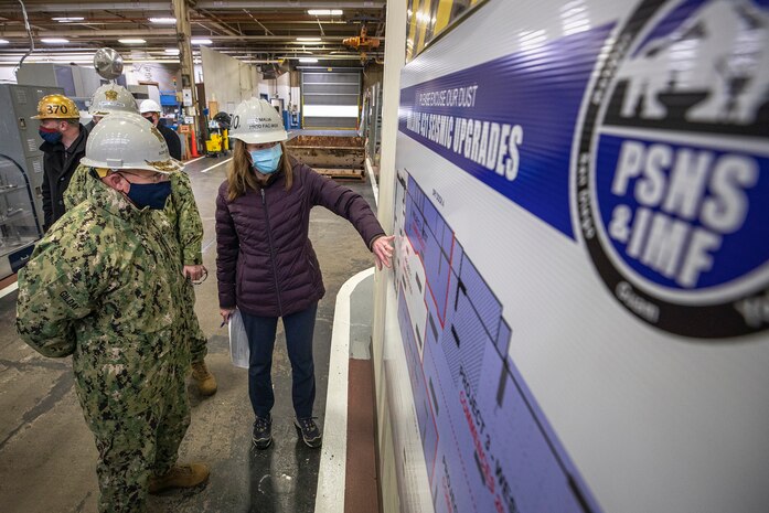 Chief of Naval Operations Adm. Mike Gilday is briefed by Amy O'Malia, Production Facilities and Plant Equipment manager, on seismic upgrades to Building 431, Dec. 16, 2020, during Gilday’s tour of Puget Sound Naval Shipyard & Intermediate Maintenance Facility in Bremerton, Washington. (PSNS & IMF photo by Scott Hansen)