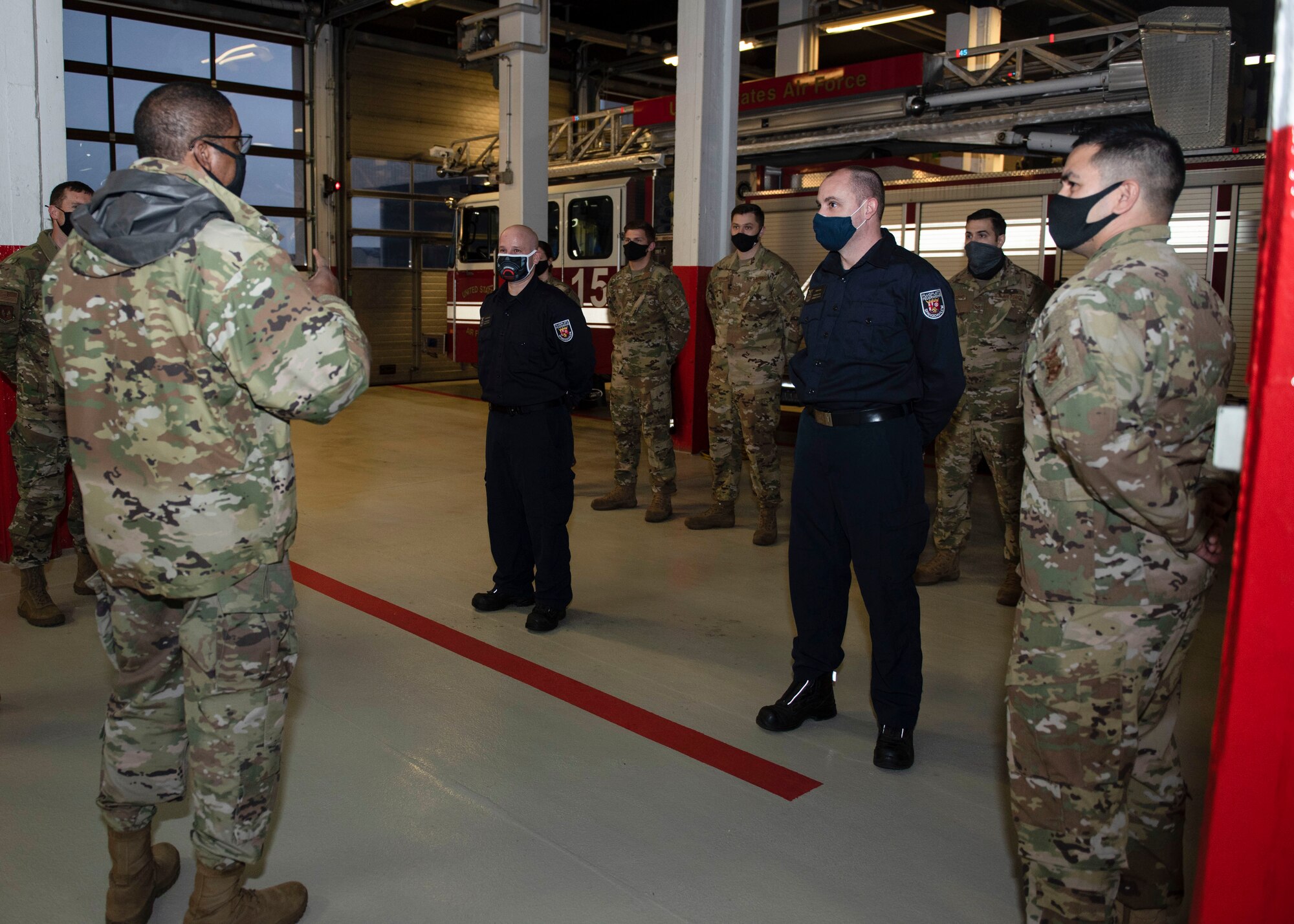 U.S. Air Force Maj. Gen. Randall Reed, Third Air Force commander, and Chief Master Sgt. Randy Kwiatkowski, Third Air Force command chief, visit the 52nd Civil Engineer Squadron Fire and Emergencies Flight, Dec. 7, 2020, at Spangdahlem Air Base, Germany. Reed and Kwiatkowski wanted to show their appreciation and to highlight the importance of having German civilians being a part of and strengthening their team. (U.S. Air Force photo by Senior Airman Melody W. Howley)