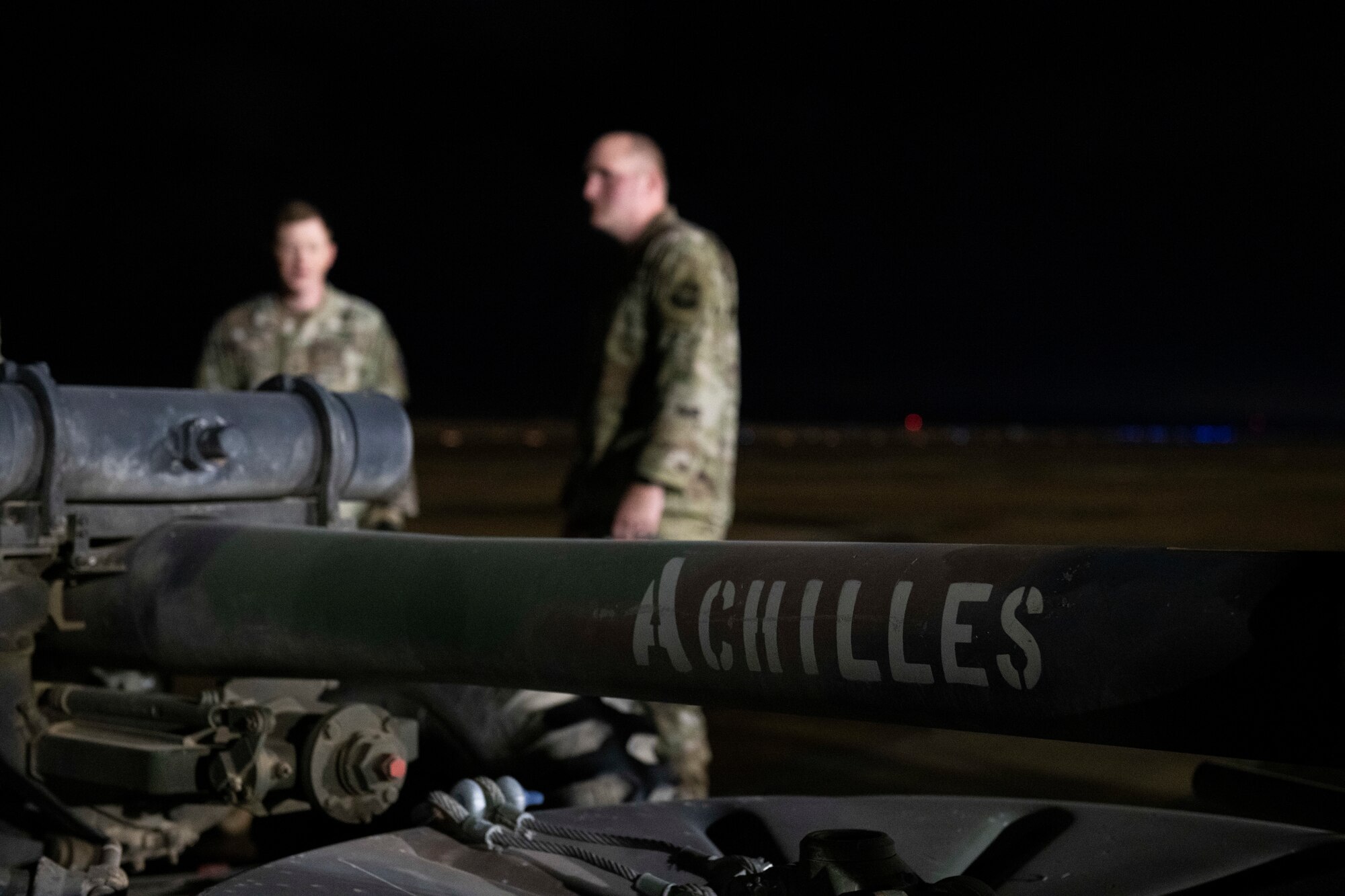 men sit on a flightline