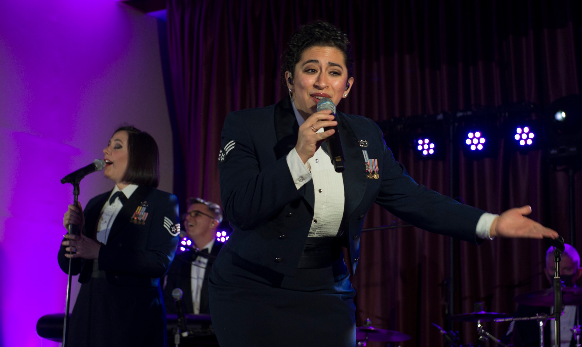 Senior Airman Alycia Cancel, U.S. Air Force Band of the Pacific vocalist, sings during the Sounds of the Season show at the Officer’s Club on Yokota Air Base, Japan, Dec. 15, 2020. Cancel sang to a live and virtual audience to spread holiday joy. (U.S. Air Force photo by Staff Sgt. Joshua Edwards)